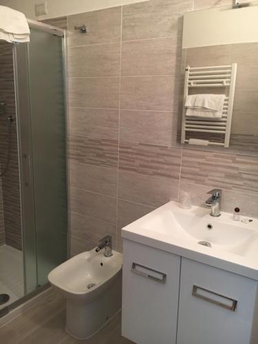a bathroom with a sink and a toilet and a shower at Antica Trattoria dell'Uva in Monza