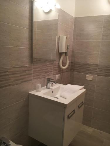a bathroom with a sink and a mirror at Antica Trattoria dell'Uva in Monza