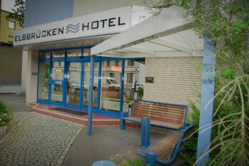 a building with a bench in front of a hotel at Elbbrücken Hotel in Hamburg