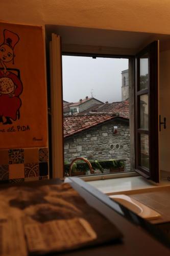 a window in a room with a view of a building at Lo Struzzo in Bagno di Romagna