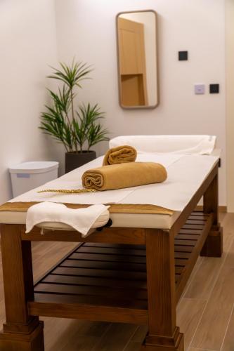 a bathroom with a wooden table with towels on it at Hotel Rubin DHS in Kruševac