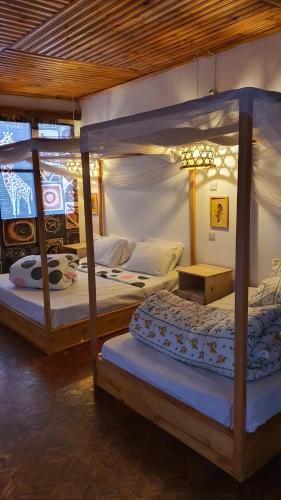 a bedroom with two bunk beds in a room at Kabila moja hostel in Iringa