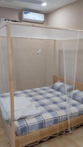 a bed with a canopy in a room at Luxury Private Villa with Pool in The Gambia in Sambuya