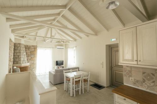 a kitchen and living room with a table and a couch at Tseralia Houses in Stoupa