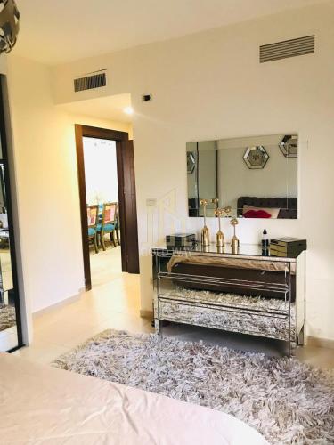 a bathroom with a large mirror and a rug at Chic 2-Bedroom - Fully Furnished in Amman