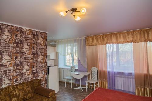 a living room with a couch and a table at Gostevay kvartiry na Melnikayte 101 in Tyumen