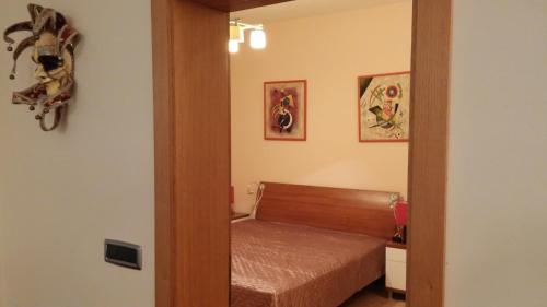 a small bedroom with a bed and a mirror at Apartments on Gorana Pavlova 24 in Sutivan