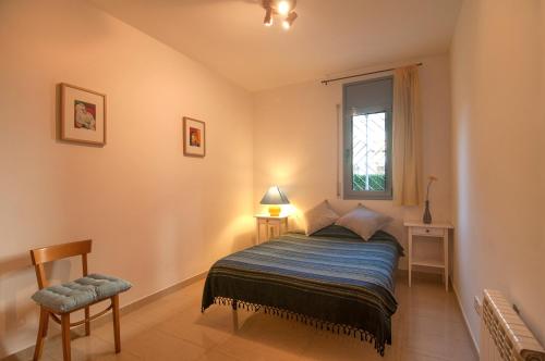 a small bedroom with a bed and a window at Hola! - Sitges by the beach in Sitges
