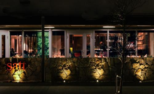 a restaurant at night with lights on a wall at Reykjavik Natura - Berjaya Iceland Hotels in Reykjavík