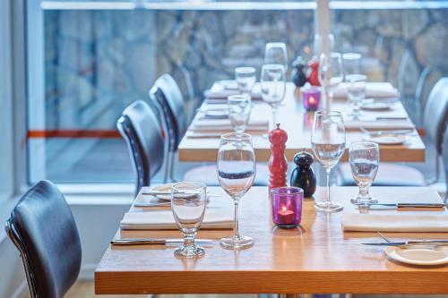 a long wooden table with wine glasses on it at Reykjavik Natura - Berjaya Iceland Hotels in Reykjavík