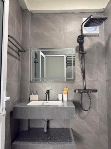 a bathroom with a sink and a mirror at FIRONA FLY HOTEL in Sapa