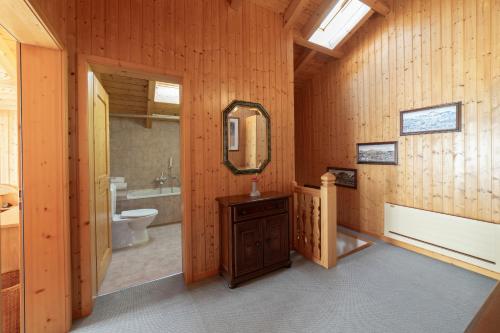 a bathroom with a toilet and a sink and a mirror at Sonnegge in Wildhaus