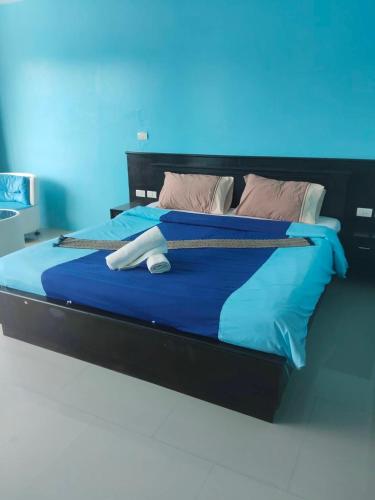 a bed in a room with a blue background at Bedroom301 Kata Beach Phuket in Kata Beach