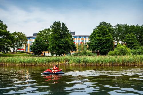 a person in a raft on a river at GrandHotel Tiffi in Iława