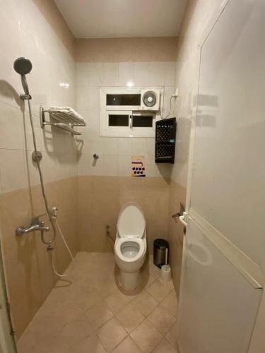 a small bathroom with a toilet in a room at مسك روز المنسك للشقق المخدمه in Quai
