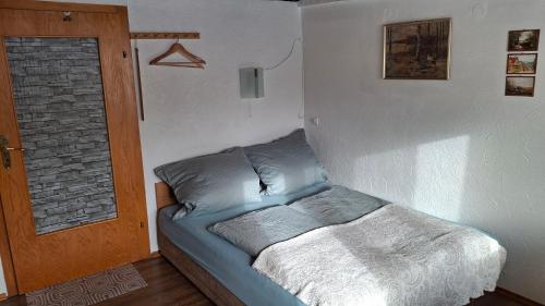 a blue couch in a room with a door at Ferienhof Ziegler - Studio Fingerhut in Baiersbronn