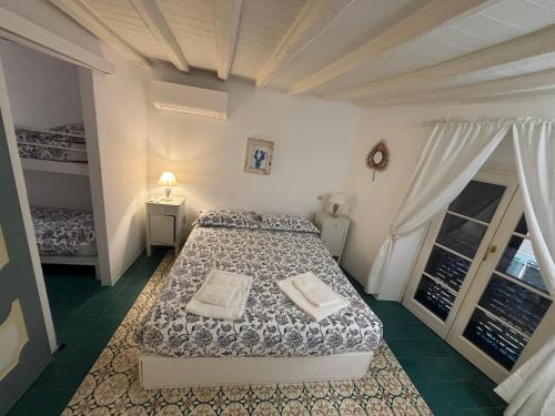 a bedroom with a bed and a window at A Casa di Letta in Santa Margherita Ligure