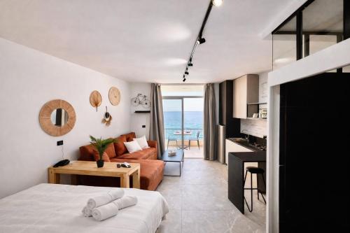 a bedroom with a bed and a living room at Gondola Marine Resort in Ḩālāt