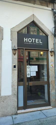 a hotel sign on the side of a building at Porta 80 House in Braga