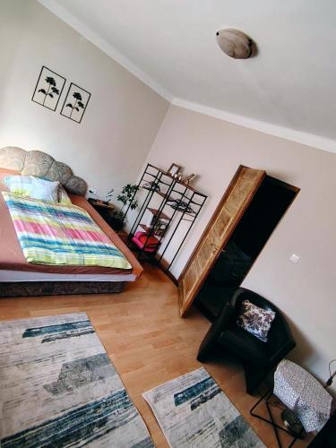 a bedroom with a bed and a staircase in a room at HeuReka Apartman in Pécs