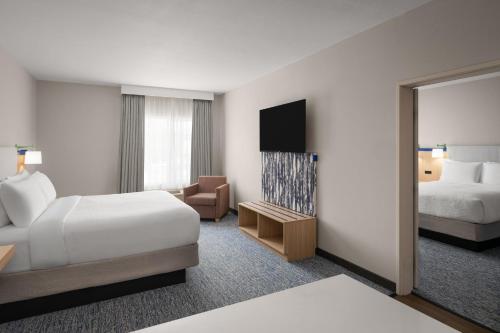 a hotel room with a bed and a television at Garner Hotel Liberty Lake by IHG in Liberty Lake