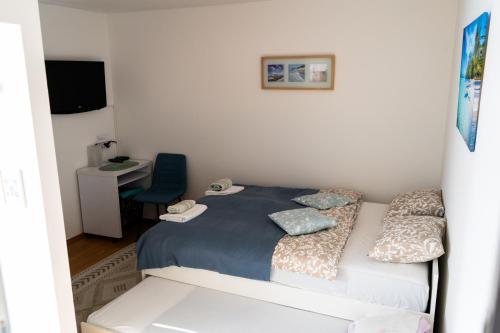 a small bedroom with a bed and a desk at Holiday House with scenic Apartment in Ptuj