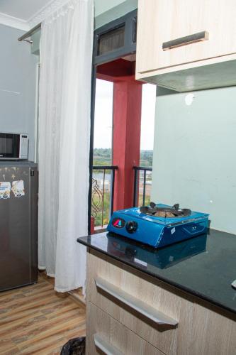 a kitchen with a blue stove on a counter at Patrach Homes in Wote