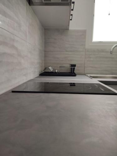 a kitchen with a sink and a counter top at By the wave luxurious studios in Piraeus