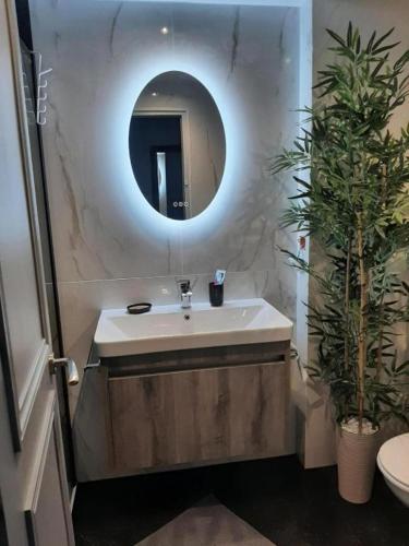 a bathroom with a sink and a mirror at Sea views-Balcony-Sleeps 6-Parking-AirCon Heating in Daimuz