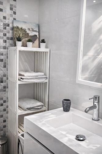 a white bathroom with a sink and a mirror at Albufeira New House in Albufeira