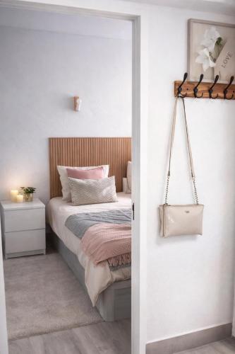 a bedroom with a bed with pink pillows at Albufeira New House in Albufeira