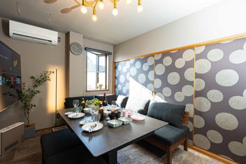 a living room with a table and a couch at 奉還町1010 in Okayama