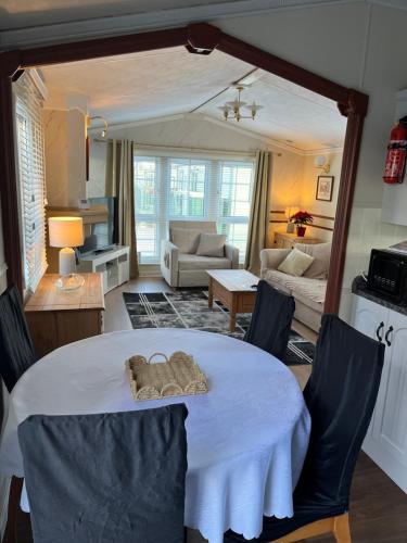 a living room with a table with a stuffed animal on it at West Cumbria static caravan in Workington