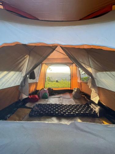 an inside view of a tent with a large opening at Thrill Playgrounds & Tipi Cafe in Libona