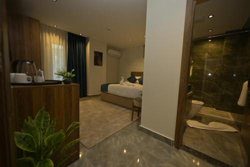 a hotel room with a bed and a bathroom at Delta Pyramids Hotel in Giza