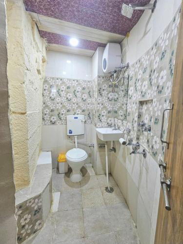 a bathroom with a toilet and a sink at Hotel Mirage in Jaisalmer
