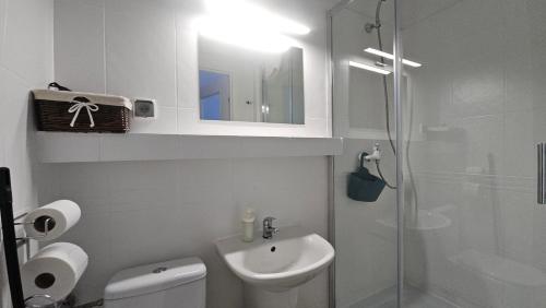 a bathroom with a toilet and a sink and a shower at Villa Podkarpacka in Kudowa-Zdrój