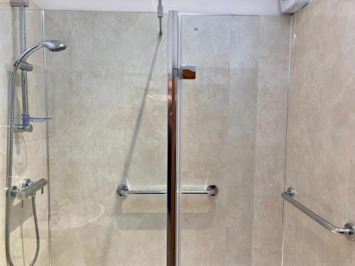 a shower in a bathroom with a glass door at The Stables in Metheringham