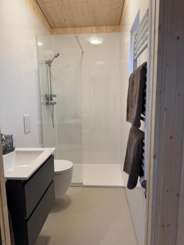 a bathroom with a shower and a toilet and a sink at New listing - Krosshóll Cottage, built in 2026 in Hella