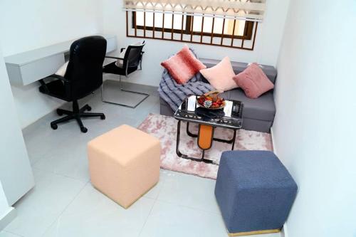 a living room with a couch and a table at Petite's Nest - Apartment 5 in Accra