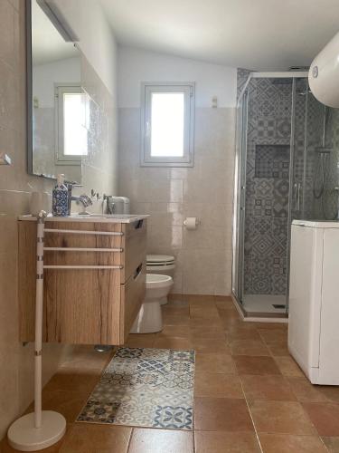 a bathroom with a sink and a toilet and a shower at Casa vacanze Madre Terra in Putignano