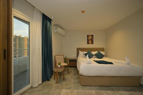 a hotel room with a bed and a balcony at Delta Pyramids Hotel in Giza