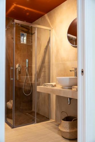 a bathroom with a glass shower and a sink at Desideri di Puglia in Barletta