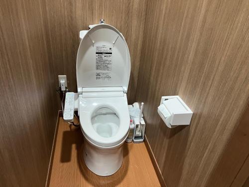 a bathroom with a toilet with the lid up at Samurai Hotel Naraiso in Narai