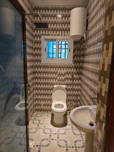 a bathroom with a toilet and a sink at Stepping Stone Apartments in Bijilo