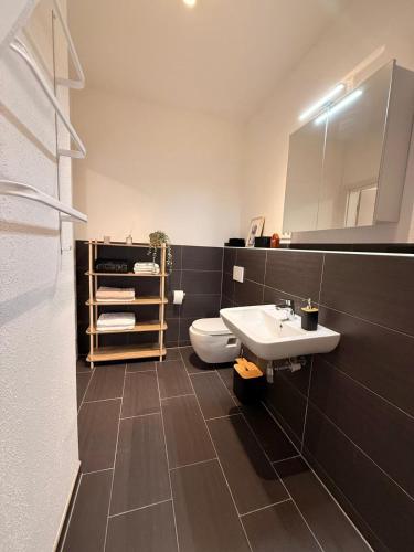 a bathroom with a sink and a toilet at Gemütliches Apartment in Kehl am Rhein