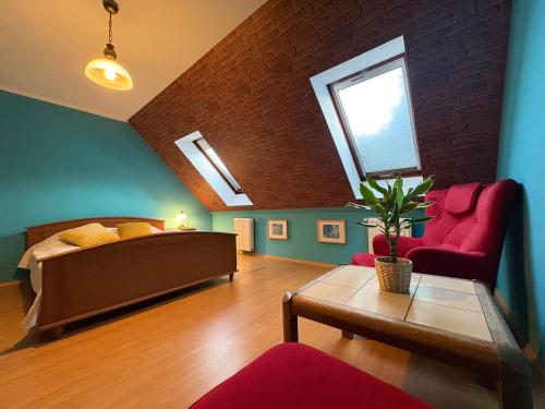 a bedroom with a bed and a couch and a table at Dom pod Jaworem in Rajcza