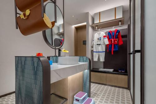 a bathroom with a sink and a mirror at EVEN Hotel Yining by IHG in Yining