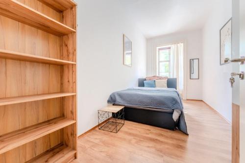 a bedroom with a bed and wooden shelves at Stadtwohnung im Zentrum in Größing