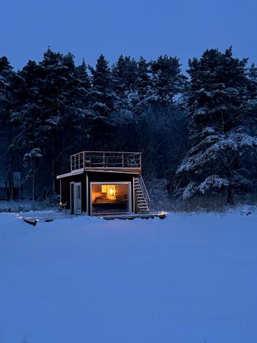 a small house with a fire in the window at Angervaksa LoodusSpa in Laugu